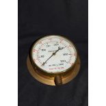 Vintage brass cased pressure gauge with scale in pounds per inch and feet of water, no maker's