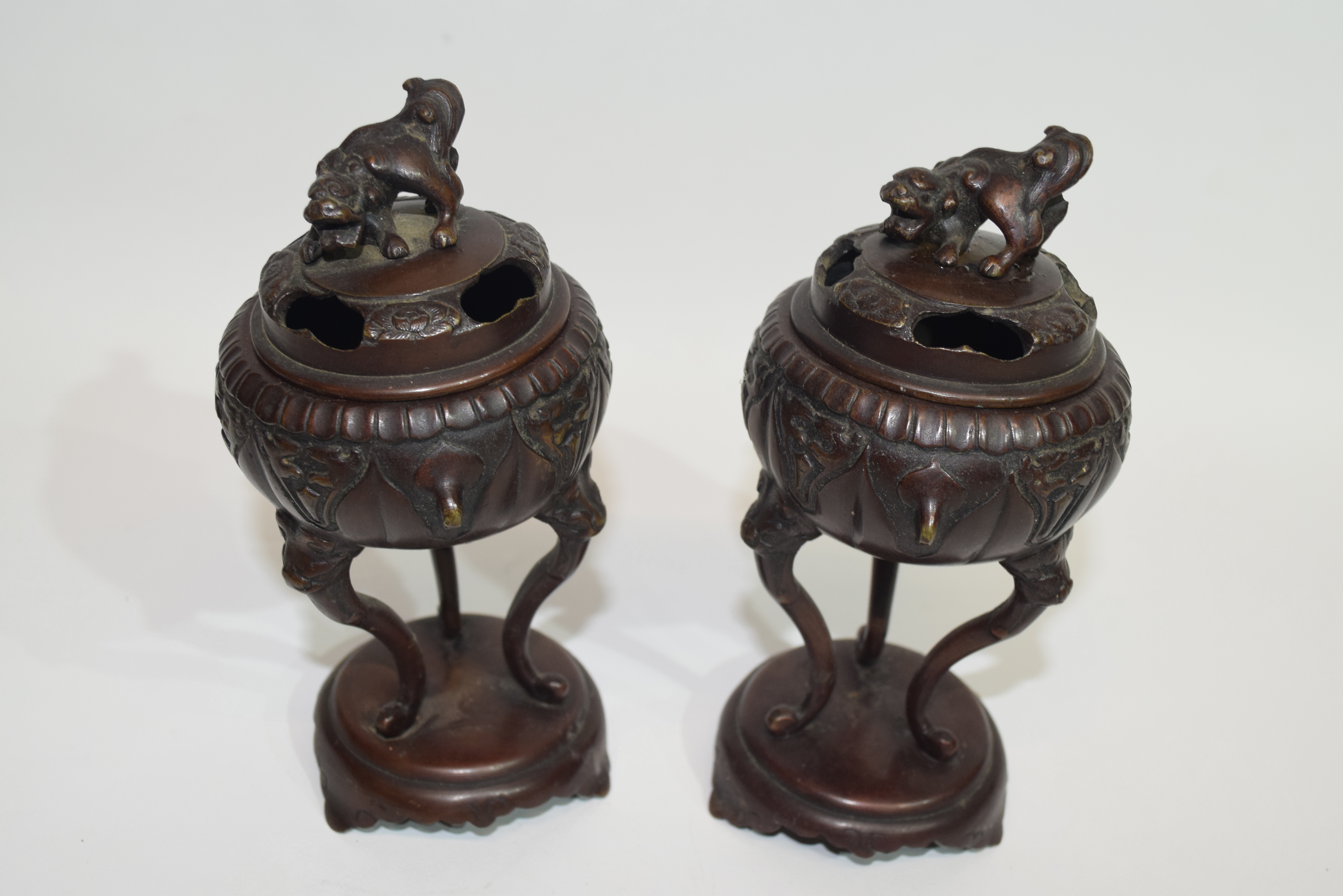 Pair of Oriental censers on oval stands, the censers raised on three elongated feet, the covers with