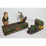 Two novelty metal money boxes, one modelled with golfers, the other modelled as a frog (2)