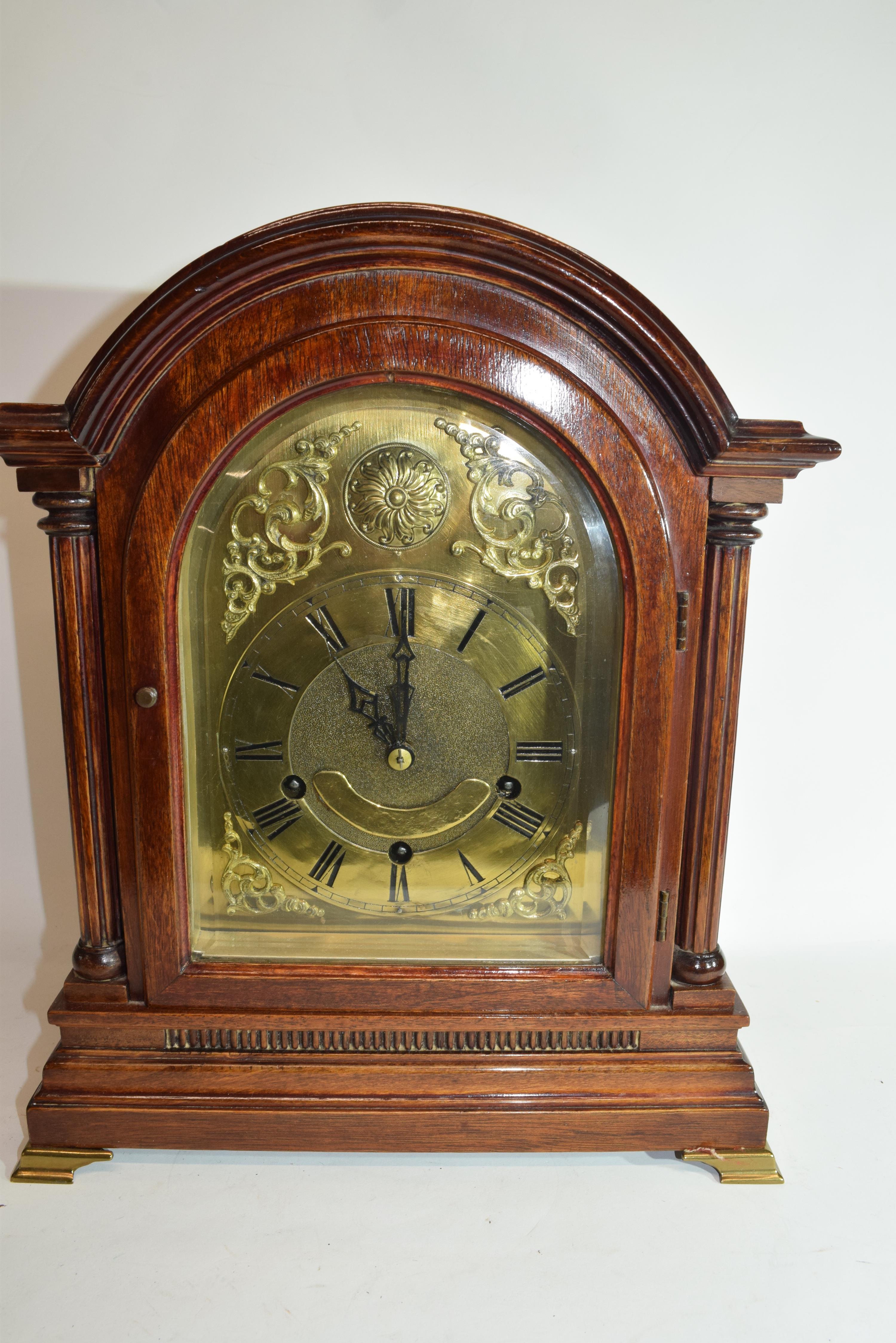 Edwardian mantel clock of large proportions with unsigned arched brass dial decorated with pierced