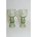 Two green glass wine glasses in Venetian style, the stems with raspberry style prunts on ribbed