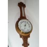 W Norris, Saxmundham, a late 19th century oak cased aneroid barometer and thermometer combination