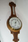 W Norris, Saxmundham, a late 19th century oak cased aneroid barometer and thermometer combination