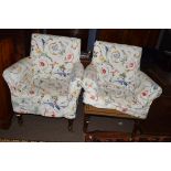 Pair of bow back armchairs with mahogany frames and turned front legs with brass casters, fitted