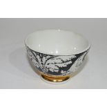 Small bowl decorated in black and white with a design by Fornisetti, with a gilt line below, the