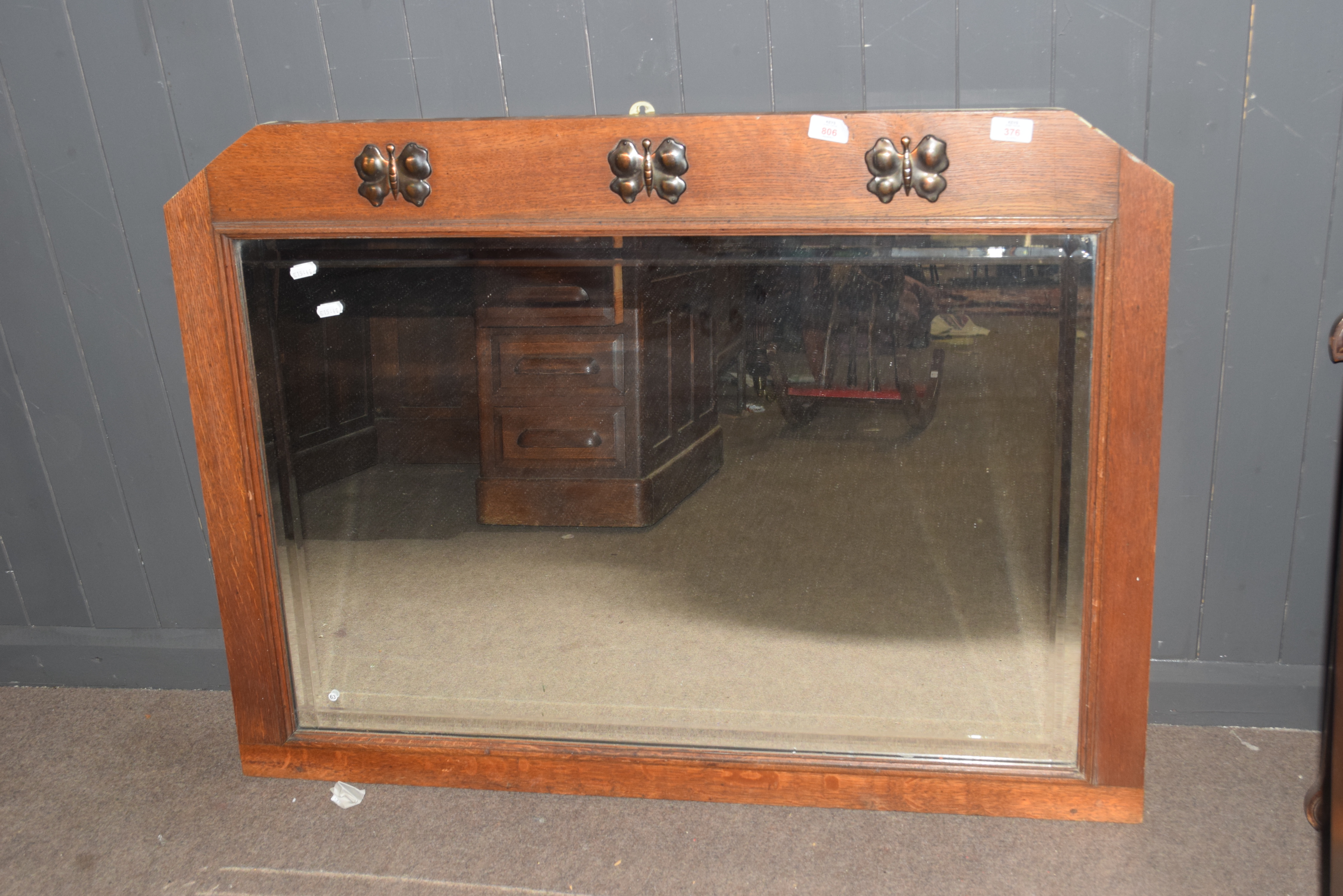 Early 20th century oak framed overmantel mirror of rectangular form, the frame decorated with