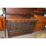 Large 18th century oak mule chest with three panelled front decorated with carved detail and