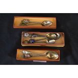 Three small boxes containing a quantity of collectors spoons with enamel finials