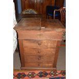 Late 19th century oak shop cabinet with fold-up lid opening to reveal an area containing mixing tub,