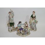 Group of Continental porcelain figurines including a gentleman and lady on oval base and two further