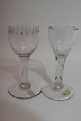 Two 18th century glasses, one with faceted stem, and further similar glass with engraving around