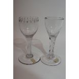 Two 18th century glasses, one with faceted stem, and further similar glass with engraving around