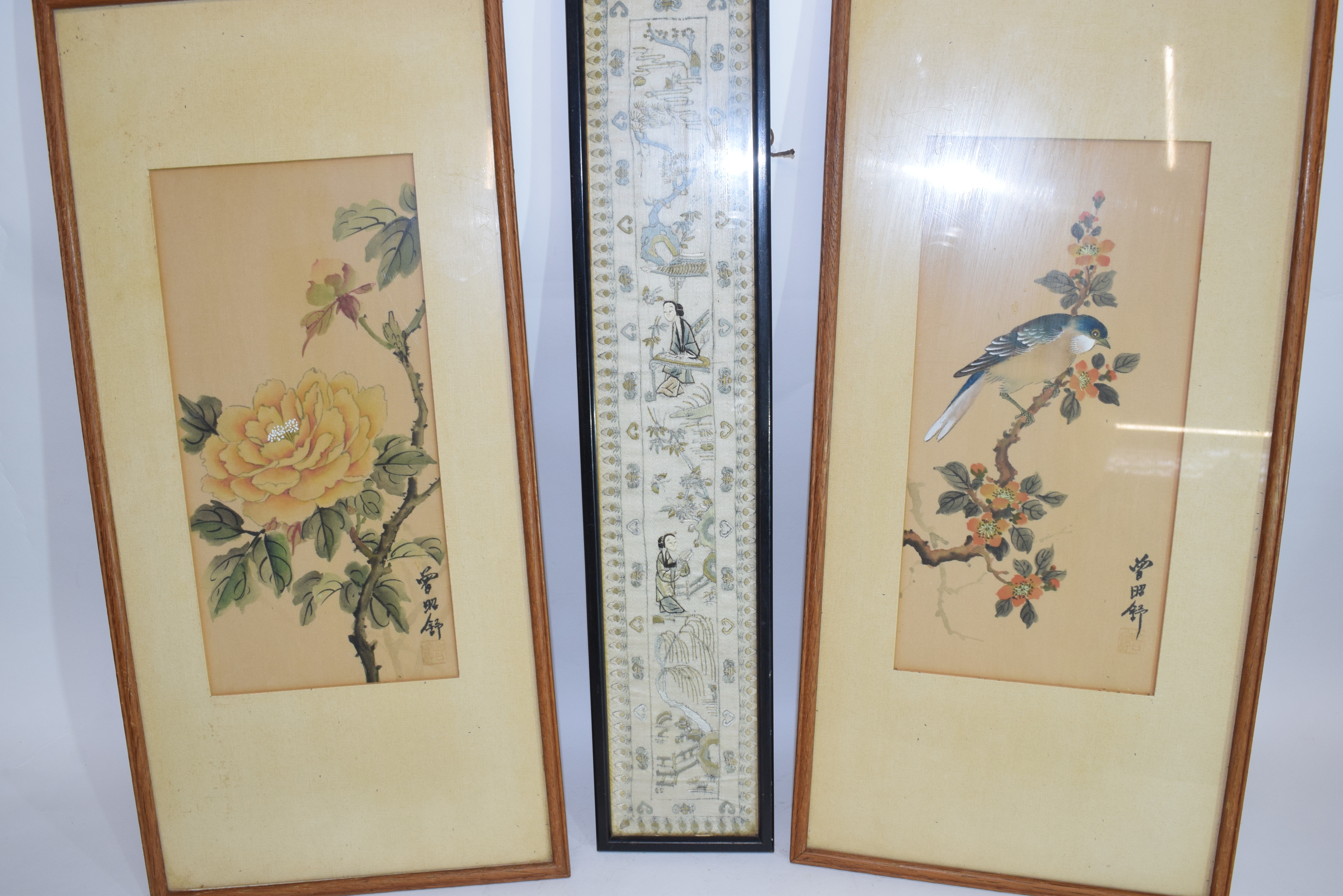 Piece of Chinese embroidery in black wooden frame together with two paintings on silk with