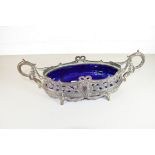 LATE 19TH CENTURY SILVER PLATED CENTREPIECE VASE OF OVAL FORM WITH BLUE GLASS LINER