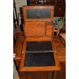 EARLY 20TH CENTURY OAK TRAVELLING STATIONERY AND WRITING BOX WITH FITTED INTERIOR AND FOLD-OUT