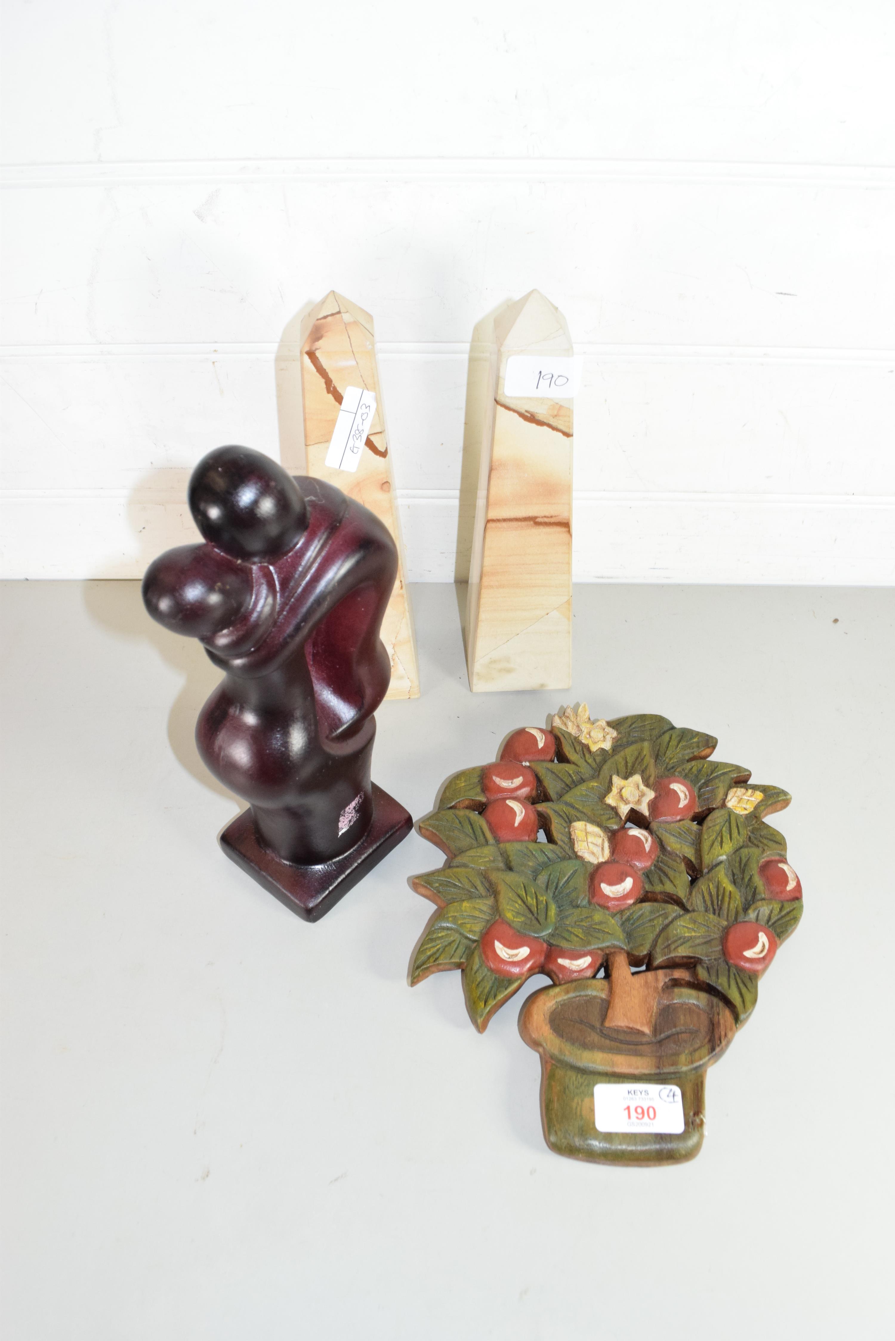 PAIR OF MODERN POLISHED STONE OBELISKS, HARDWOOD FRUIT DECORATED WALL PLAQUE AND A POLISHED WOODEN