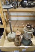 Box containing three vintage oil lamps