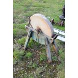 Vintage grinding wheel on wooden frame