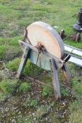 Vintage grinding wheel on wooden frame