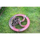 Vintage red painted hand crank wheel, 49cm diam, together with a further small iron implement wheel,