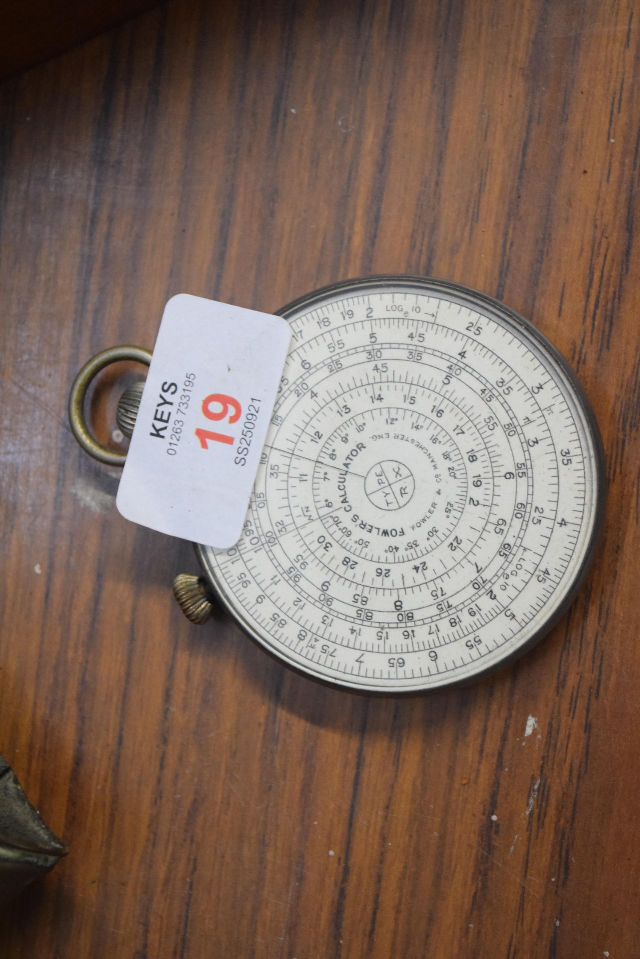 Mathematical interest - a Fowlers circular calculatore Type RX set in a base metal surround, 6.5cm