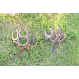 Two blacksmith made baskets from horseshoes, together with two further similar stands