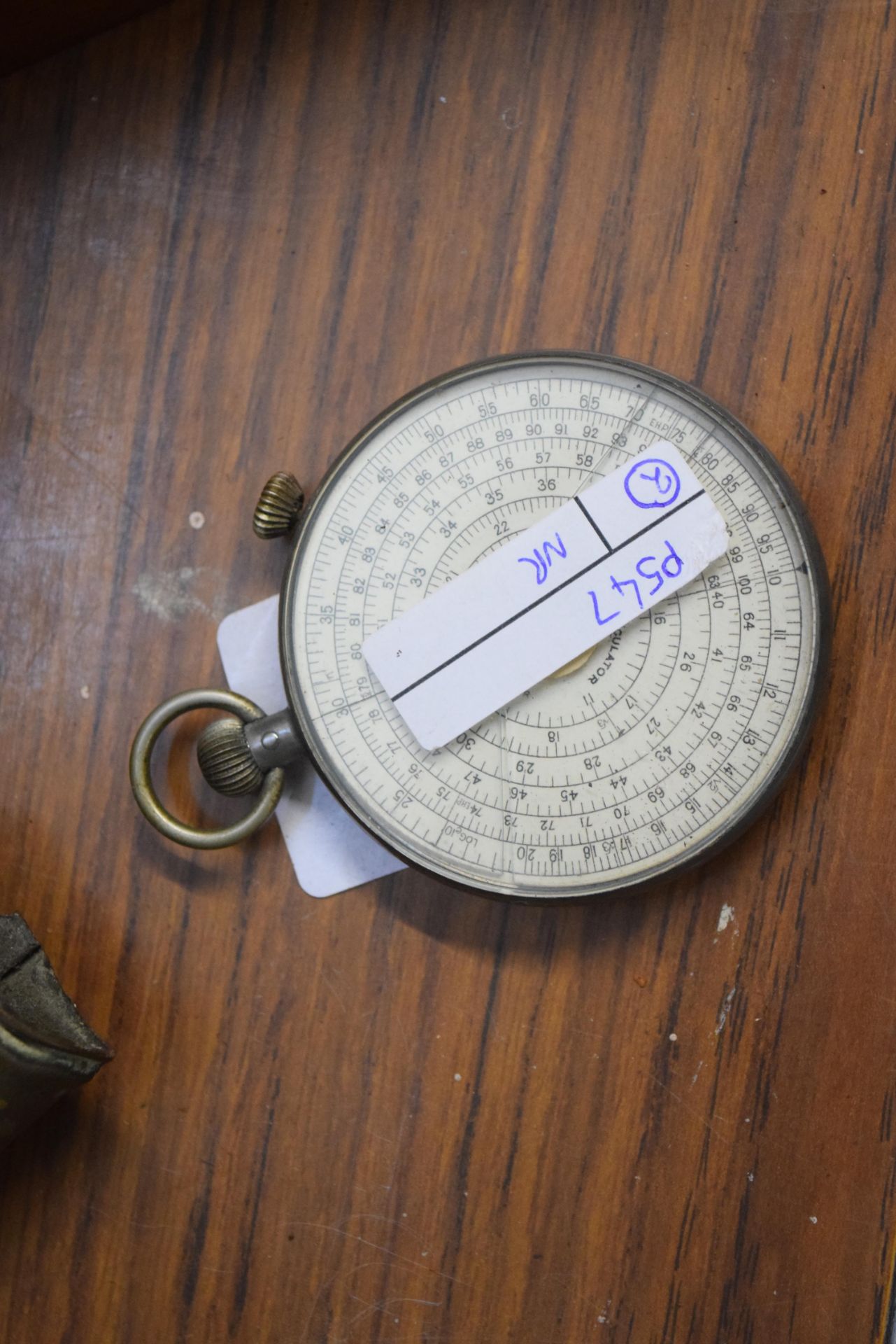 Mathematical interest - a Fowlers circular calculatore Type RX set in a base metal surround, 6.5cm - Image 2 of 2