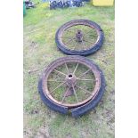 Pair of vintage iron ten spoke wheels with solid rubber tyres, wheels approx 78cm diam ex tyres