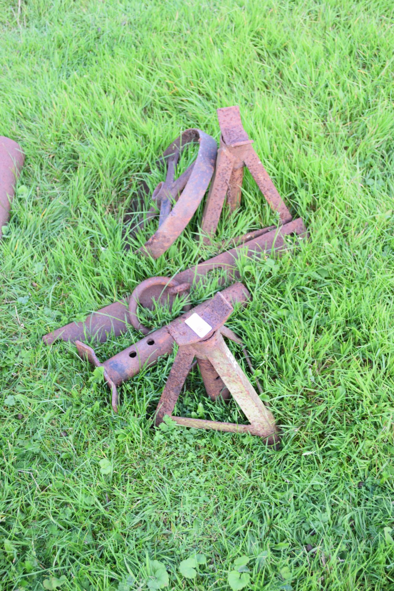 Pair of iron axle stands and a vintage iron wheel