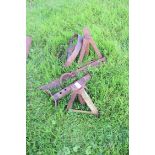 Pair of iron axle stands and a vintage iron wheel