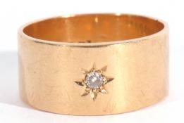 18ct gold and diamond set wide band ring, the plain polished band with a small diamond in a star