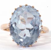 Blue faceted single stone ring of oval shape, 16 x 8mm, in a coronet setting, stamped 9ct, size K