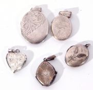 Hallmarked silver hinged oval locket, together with four white metal small examples