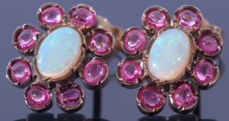 Pair of opal and ruby cluster earrings, the centre with a cabochon opal bezel set between 8 small