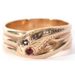 9ct gold serpent ring, the chased head with two small garnet set eyes resting on a coiled body