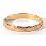 Rolled gold vintage hinged bracelet of oval shape, part chased and engraved, stamped 1/5 9ct R.G.