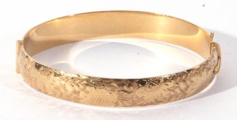 Rolled gold vintage hinged bracelet of oval shape, part chased and engraved, stamped 1/5 9ct R.G.