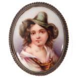 Vintage hand painted porcelain brooch of oval form depicting a young lady in a green hat, framed