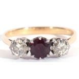 Ruby and diamond three-stone ring, the round faceted ruby flanked by two round brilliant cut