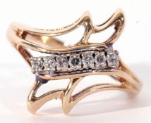 14K stamped diamond designer ring having seven small diamonds line set above a stylised open work