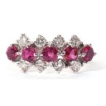 18ct white gold small size ruby and diamond cluster ring featuring a line of five circular cut