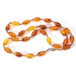 Modern cognac amber bead necklace, a single row of uniform shaped beads, 2cm diam, joined by two