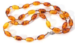 Modern cognac amber bead necklace, a single row of uniform shaped beads, 2cm diam, joined by two