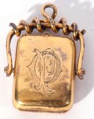 Victorian gold plated swivel locket of rectangular shape, engraved with a monogram to the front,