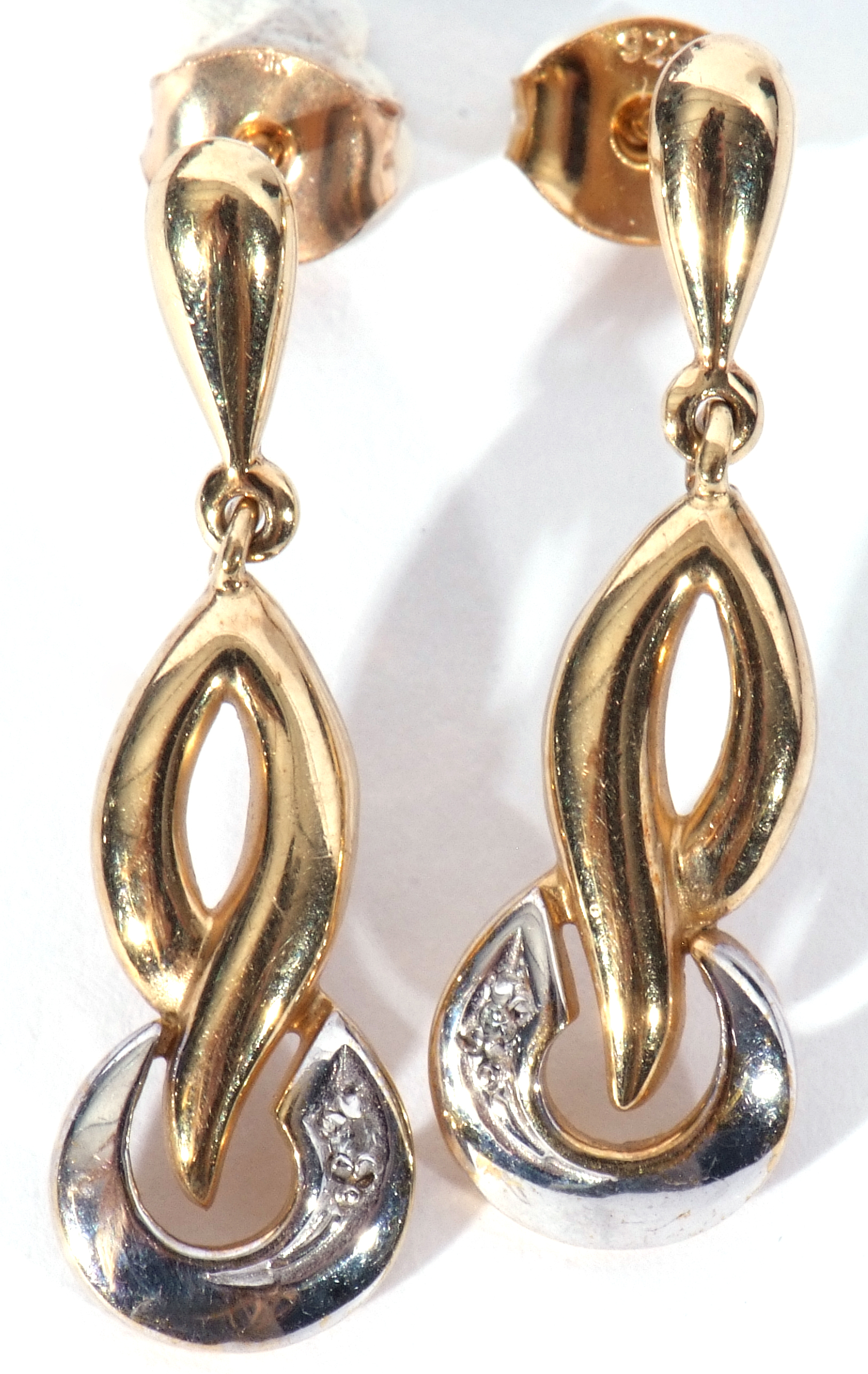 Pair of modern 9ct two-tone gold earrings in a stylised design, each highlighted with a small single