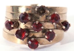 Modern 14K stamped five band stacking ring featuring 8 small garnets, (one missing), 4.5gms, size K