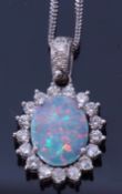 Precious metal opal and diamond pendant, the doublet opal four claw set and raised within a