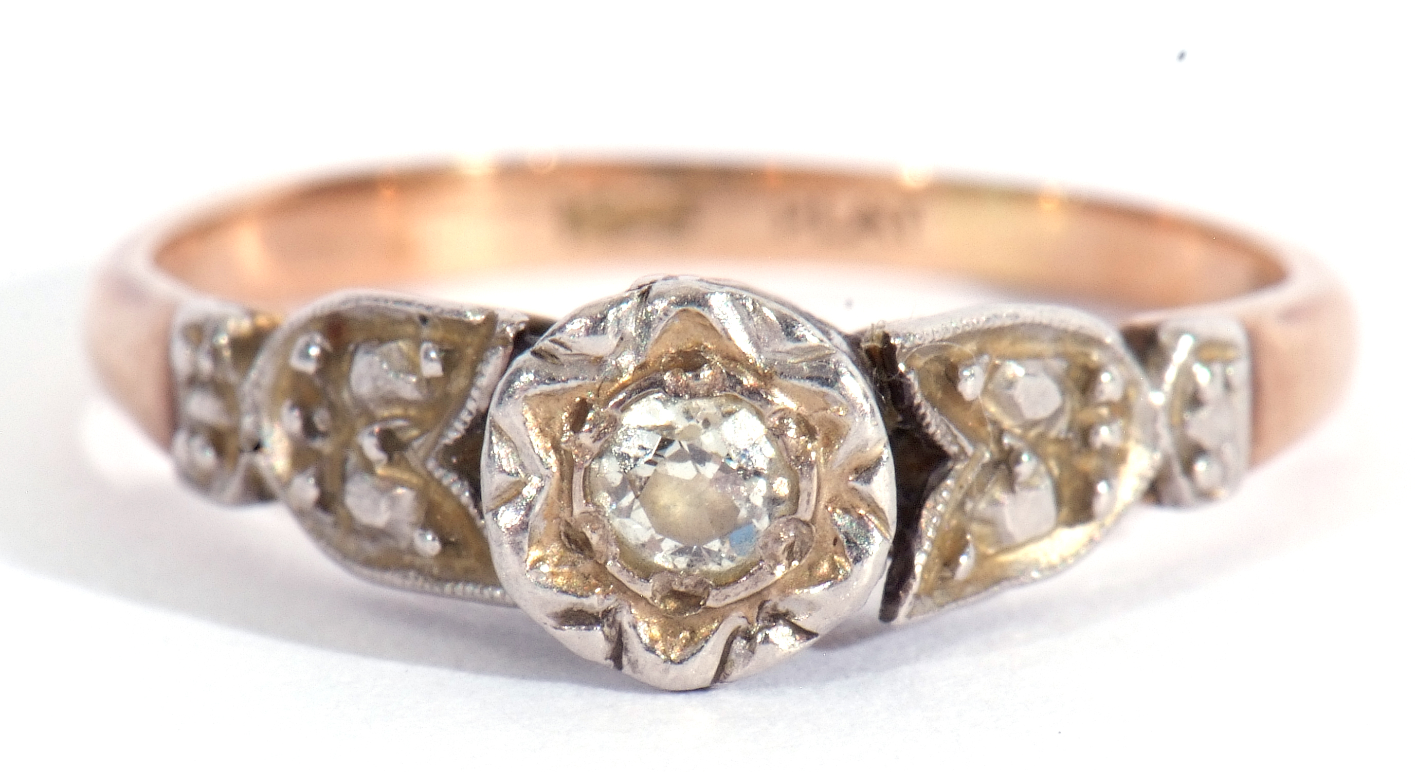 Diamond single stone ring featuring a small old cut diamond in illusion setting raised between