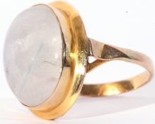 Large quartz dress ring, the oval cabochon quartz 12 x 8mm, bezel set in a yellow metal plain