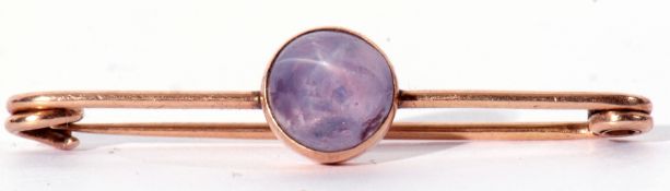 Yellow metal and amethyst brooch, the round cabochon amethyst in cut down setting to a pin brooch,
